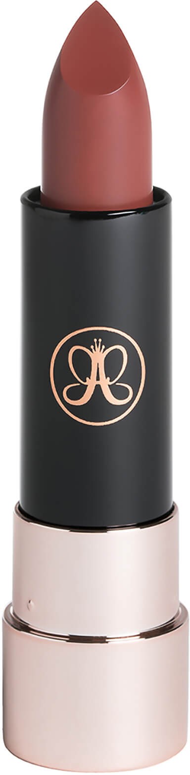 A lipstick in a black case with a gold logo, showing a pinkish-brown color.