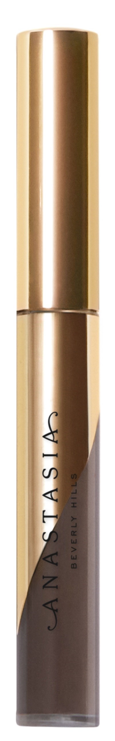 Ein Tuben mit goldener Kappe und beigem Körper, beschriftet 'Anastasia'. Es sieht aus wie ein Kosmetik- oder Hautpflegeprodukt.