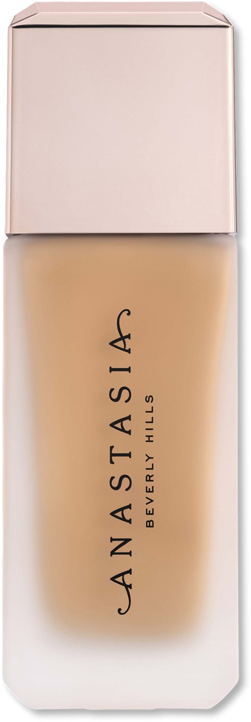 En foundationflaska med en ljus rosa lock och klart glas som visar beige vätska inuti.