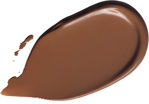 Ett stryk av brunt flytande choklad med slät textur och rund form.