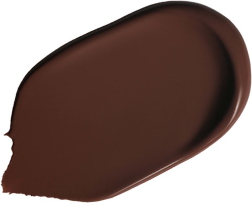 En brun smet eller stänk av make-up, troligen foundation eller concealer, på svart bakgrund.