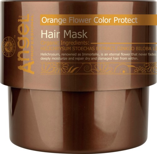 En brun burk med hårmask märkt med orange och guldig text, nämner ekologiska ingredienser och hårreparerande fördelar.