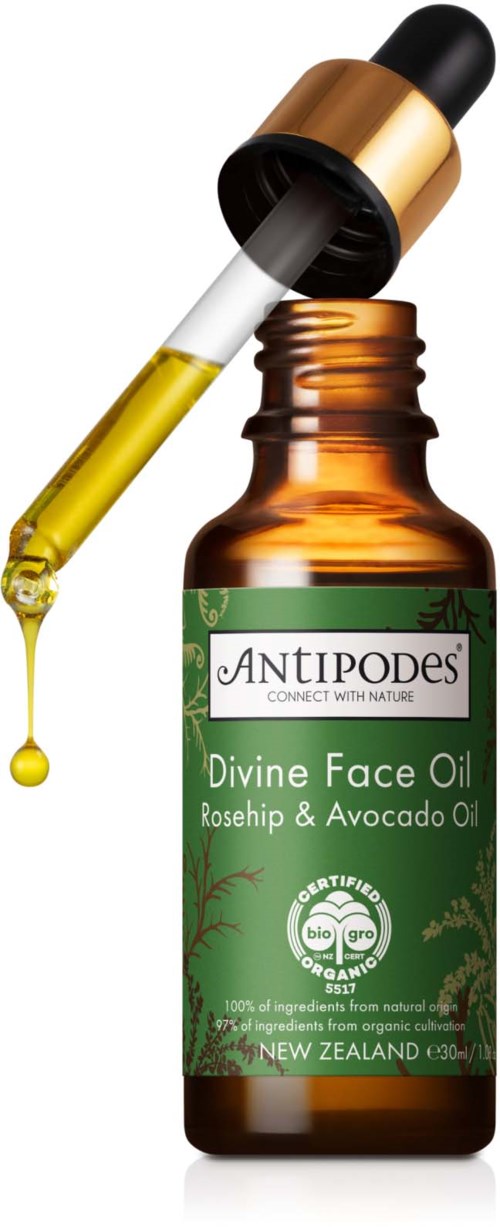 Mała zielona butelka z pipetą, oznaczona 'Divine Face Oil' z olejem różanym i awokado, od Antipodes.