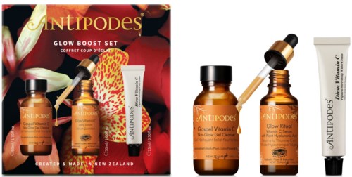 Ett uppsättning hudvårdsprodukter med orange flaskor, en pipett och en vit tub, märkta 'ANTIPODES' och 'Glow'.
