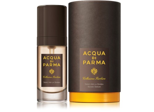 En liten skäggserumflaska bredvid en cylindrisk svart ask, båda märkta 'Acqua di Parma Cedrina Barberia.'