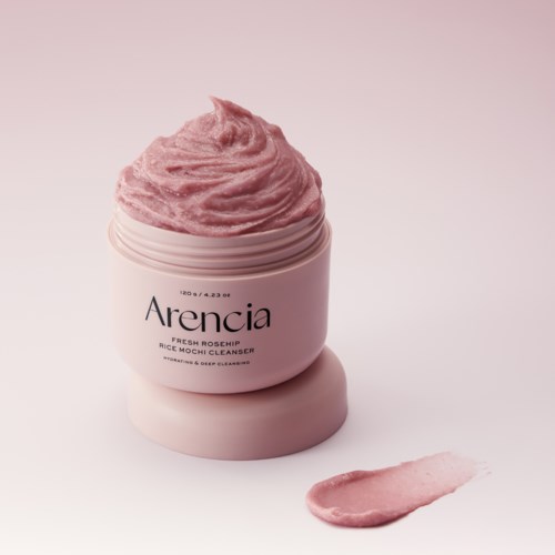 En rosa kruka med hudvårdsgrädde märkt Arencia Fresh Rosehip med lite grädde och en liten smet utanför.