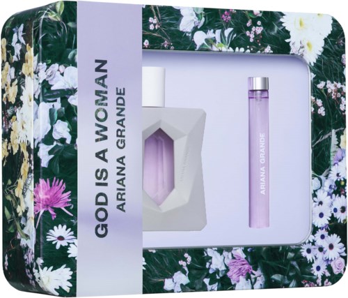 A perfume set with a white bottle, pink perfume spray, and packaging with floral patterns and the words "God is a Woman."