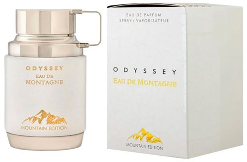 Biała butelka perfum i jej opakowanie z górami i tekstem, oznaczone jako Odyssey Eau de Montagne Mountain Edition.