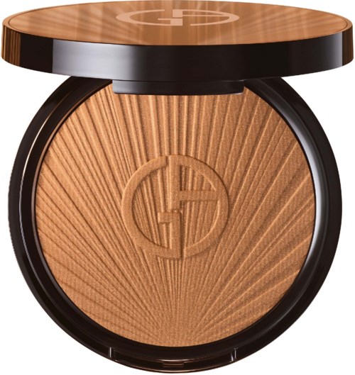 A compact powder with sunburst design, a logo in the center, and a wooden top lid.