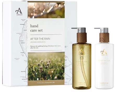 A skincare set includes a box with text, a leaf illustration, and two bottles, one with yellow liquid and one white.