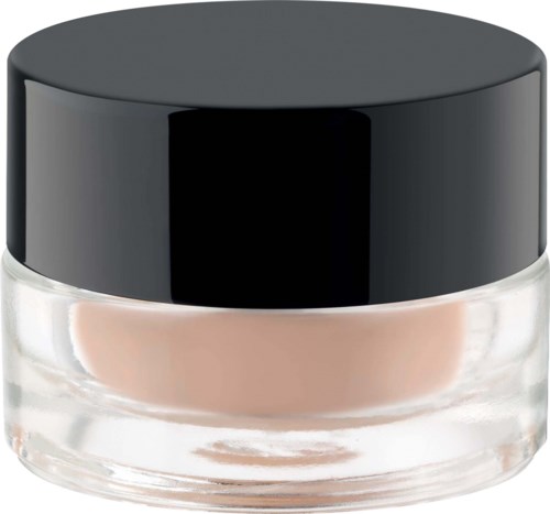A small round glass jar with a black lid, containing light beige cream or moisturizer.