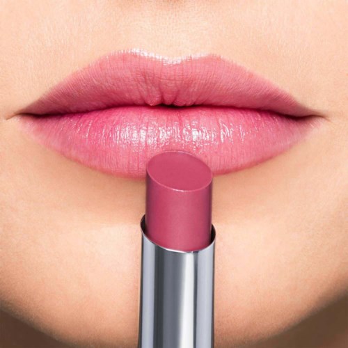 Close-up of lips with pink lipstick and a lipstick tube below them.