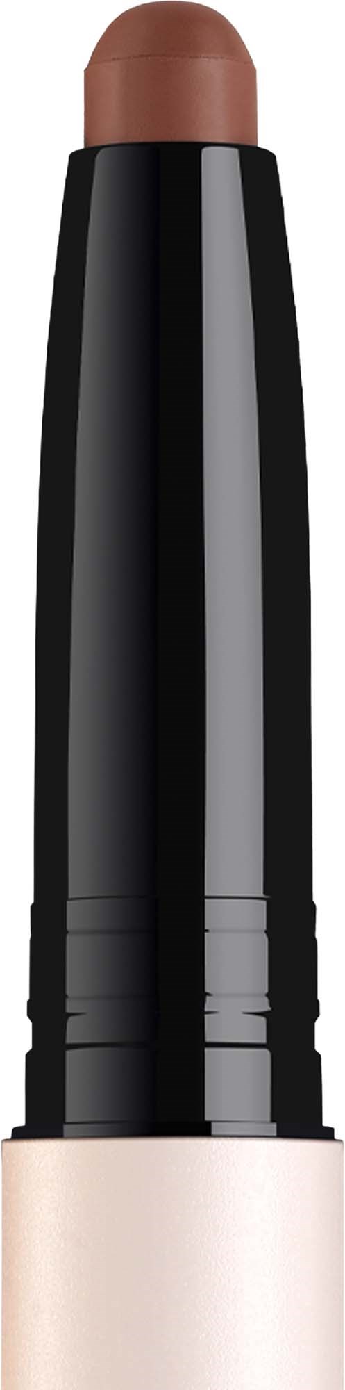 Creamy beige lipstick in a black and white tube with a pointed tip.
