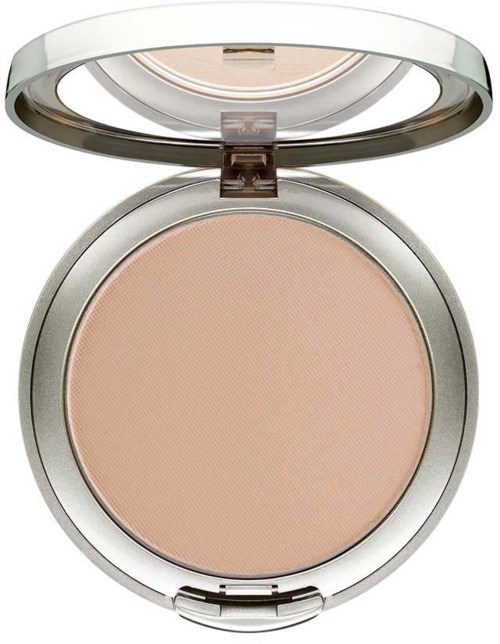 A round makeup compact with beige powder inside and a shiny silver lid. The lid is open, showing the powder.