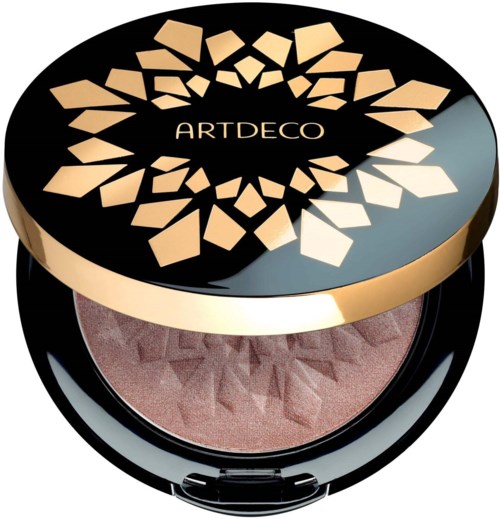 En rund makeup-kompakt med svart och guld lock, visar ett geometriskt mönster och märket 'ARTDECO'.