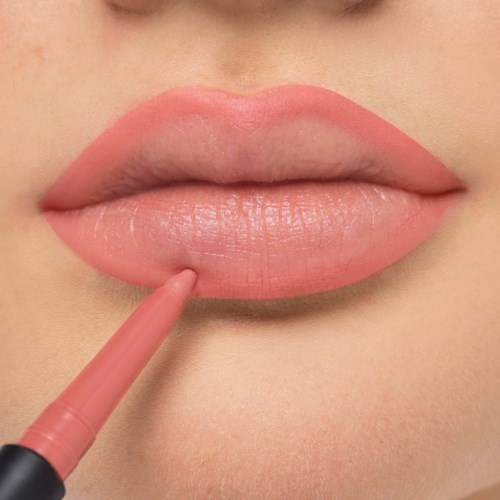 Close-up of lips being outlined or colored with a pink lip pencil or gloss.
