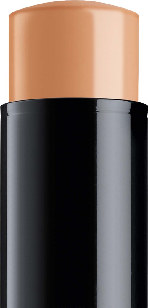 A skincare stick in a black and peach container.