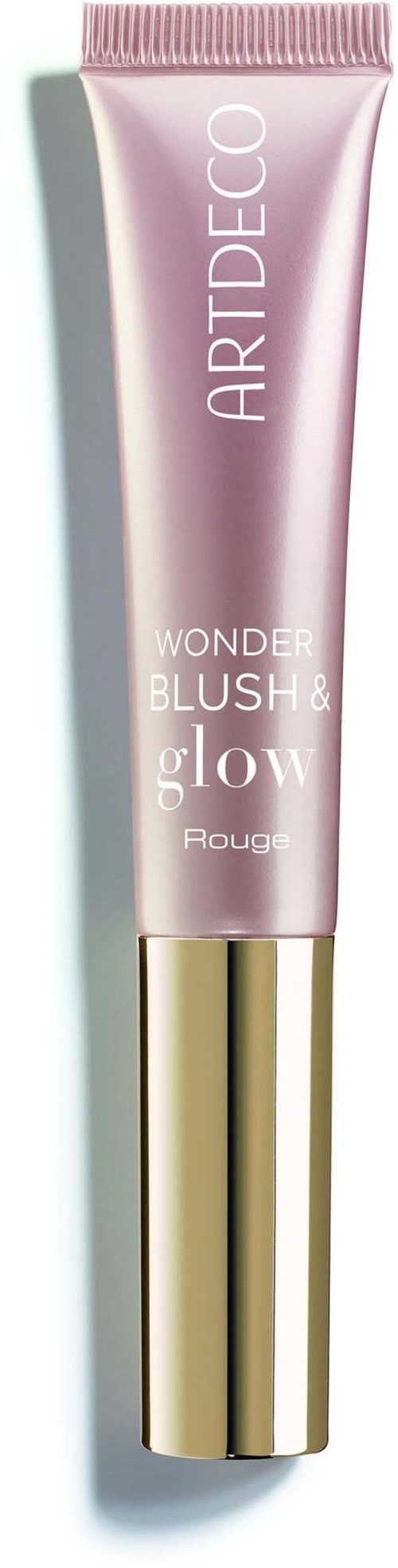 A pink tube of makeup with a gold cap, labeled Wonder Blush Glow by ART DECO.