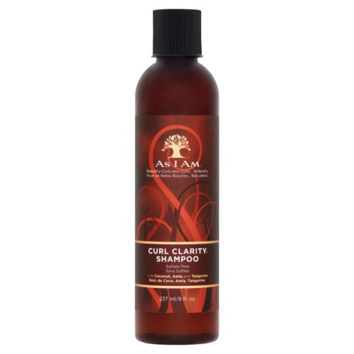Eine braune Flasche mit Curl Clarity Shampoo, schwarzer Deckel, rotes und weißes Etikett mit Produktname.