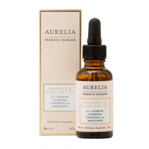 A small brown bottle with a black dropper cap, labeled Auraelia Probiotic Skincare, Balance & Glow Day Oil, ingredients listed.