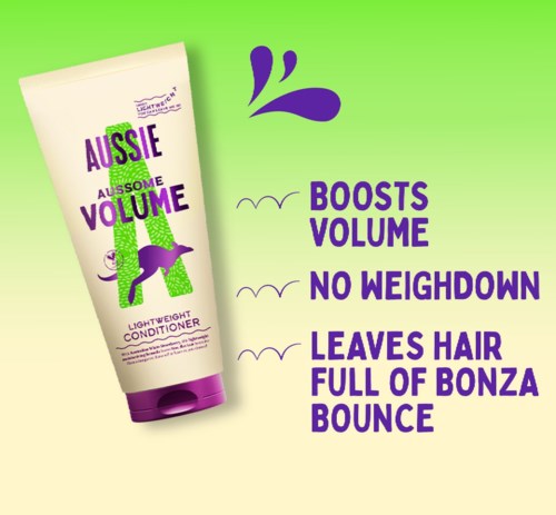 Shampoopullo mainostaa Aussie leave-in -hoitoainetta, joka lisää volyymia ja tekee hiuksista iloisesti pompovat.