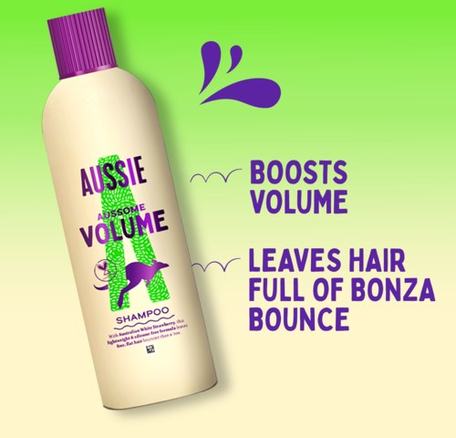 Shampoopullo, jossa on violetti korkki ja vihreä tausta, teksti lisää volyymi ja hiukset pomppivat.