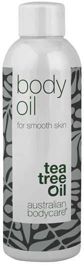 En vit flaska märkt 'body oil' med 'tea tree oil' skrivet, avsedd för jämn hud, av Australian Bodycare.