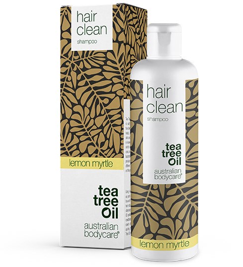 En sjampo-flaske med brunt og gullbladmønster, merket 'hair clean' og 'lemon myrtle, tea tree oil'.