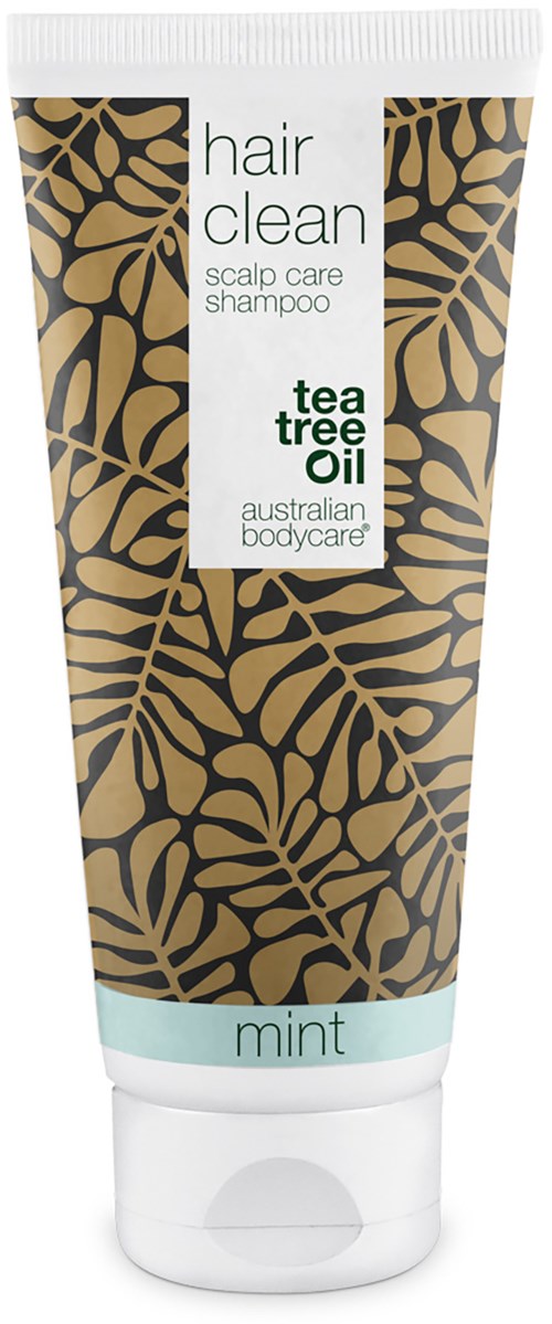 En tube med sjampo med svart og gull bladmønster, merket 'Hair Clean' med tea tree olje for hodebunnspleie, og 'mint' nederst.