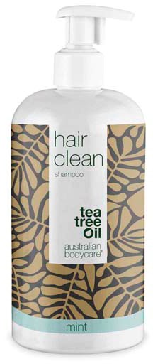 En hvit sjampo-flaske med pumpe, merket 'hair clean' med tea tree olje, mint duft og bladmønster.