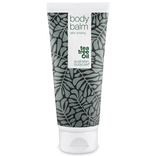 En tub med kroppsbalsam med grön och svart lövmönster, märkt 'body balm after shaving tea tree oil'.