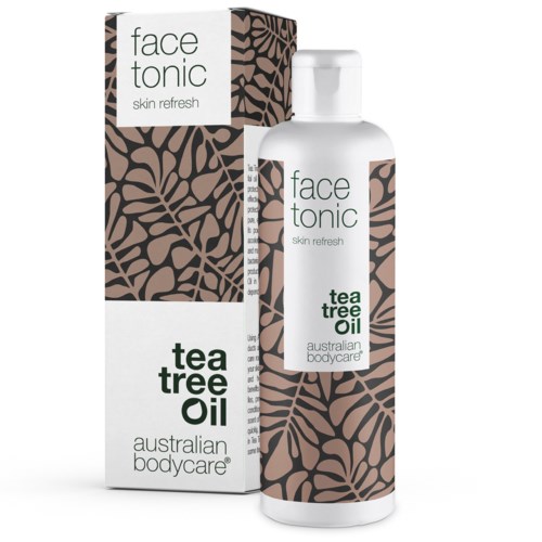 En hudvårdsflaska och ask märkt 'face tonic' med 'tea tree oil' från Australian Bodycare, med bruna bladmönster.