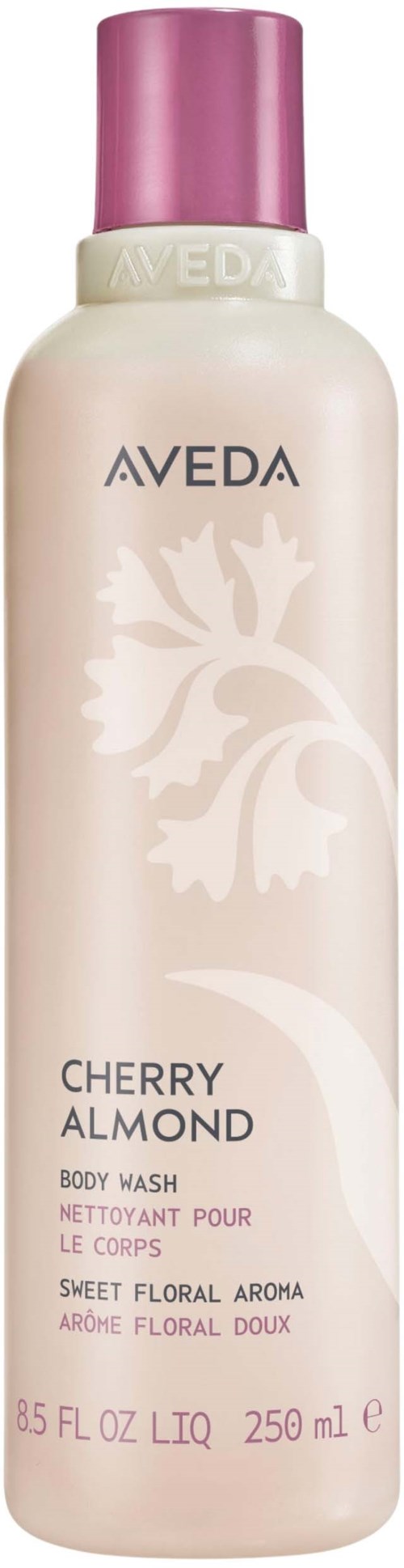 En lang rosa og hvit flaske av Aveda cherry almond kroppvask med floral duftetikett.