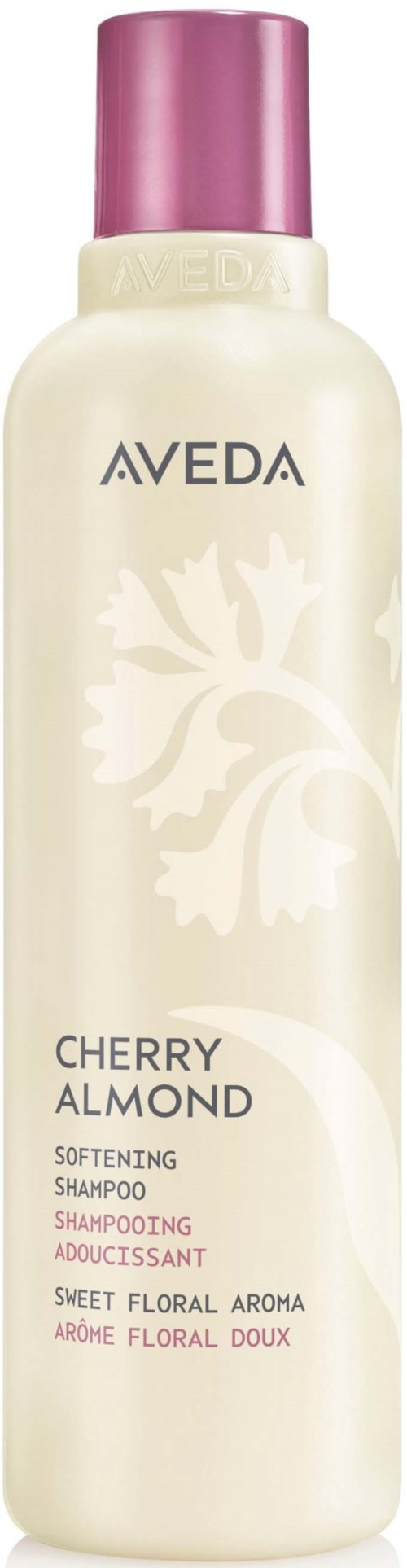 Aveda Cherry Almond pehmentävä shampoopullo vaaleanpunaisella korkilla ja kukkakuviolla kauluksessa.