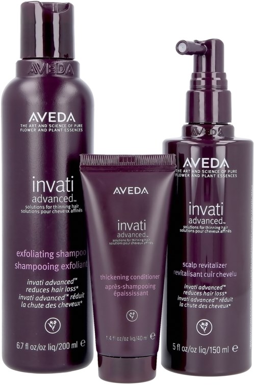 Tre Aveda Invati hårvårdsprodukter: schampo, balsam och scalp revitalizer, alla i lila flaskor med silverdetaljer.