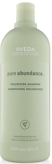 En lys grønn flaske med Aveda Pure Abundance volumgivende sjampo med hvit lokk.