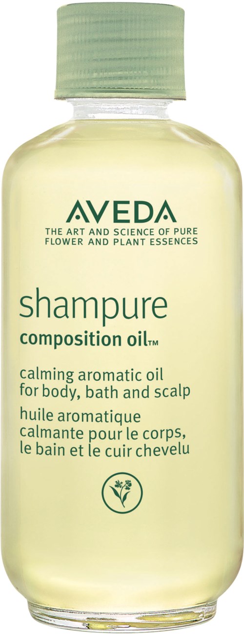 Läpinäkyvä muovipullo Aveda-shampoolla, valkoinen korkki, sisältää vaaleankeltaista nestettä, merkitty päänahalle ja keholle.