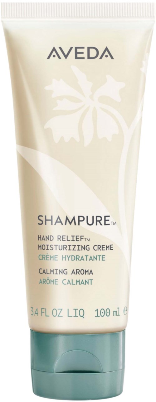 En tube med Aveda-shampoo i hvid og grøn design med blomstermønster og produktoplysninger.