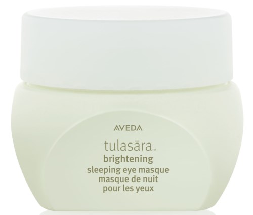 En vit burk märkt 'Aveda Tulasaara Brightening Sleeping Eye Masque' för nattbruk.