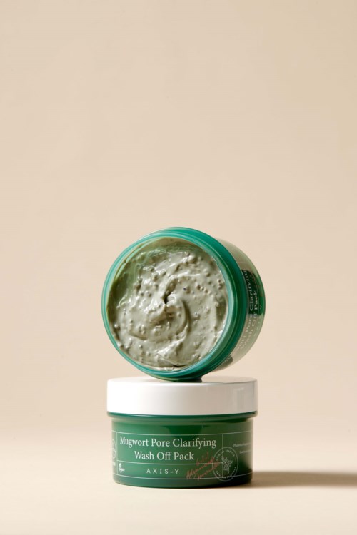 A small green jar with a lid, containing a creamy skincare product, labeled "Magwort Pore Clarifying Wash Off Pack."