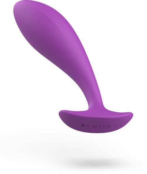 En lilla buet genstand med en flad base, sandsynligvis en massage- eller stimuleringsenhed.
