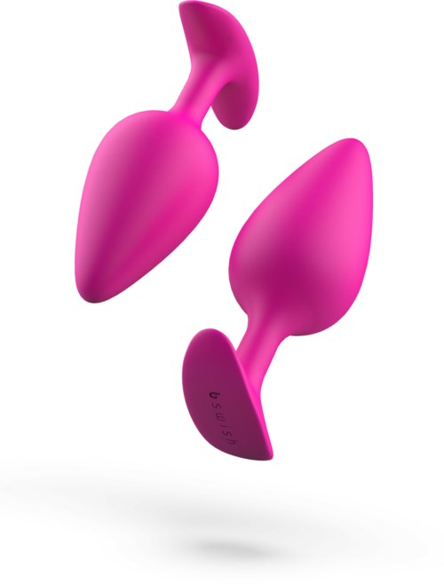 Zwei rosa Silikon-Geräte mit abgerundeten Enden, für Freude oder persönliche Verwendung. Sie haben eine glatte Oberfläche und ergonomische Form.