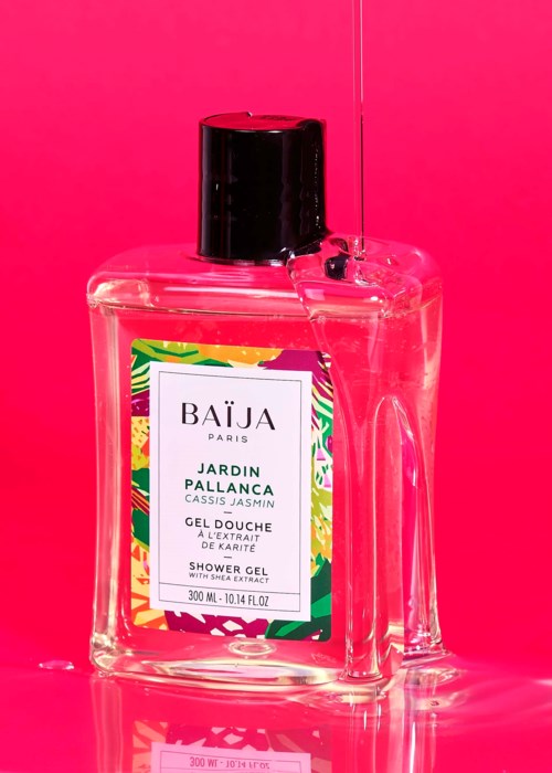 Jasnoróżowe tło z przejrzystą butelką żelu pod prysznic oznaczoną 'Jardin Pallanca, Cassis Jasmine'.