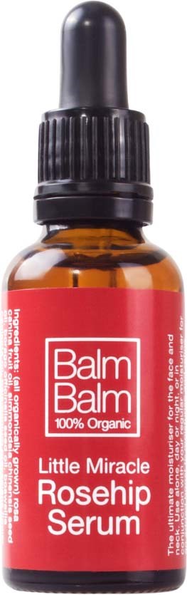 Mała bursztynowa butelka z kroplomierzem, oznaczona 'Balm Balm Little Miracle Rosehip Serum'.