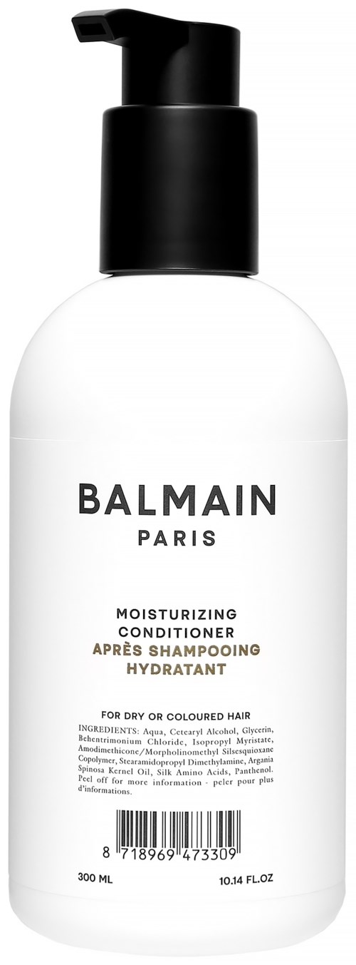 En hvit flaske med svart pumpe, merket Balmain Paris, fuktighetsgivende balsam for tørt eller farget hår.