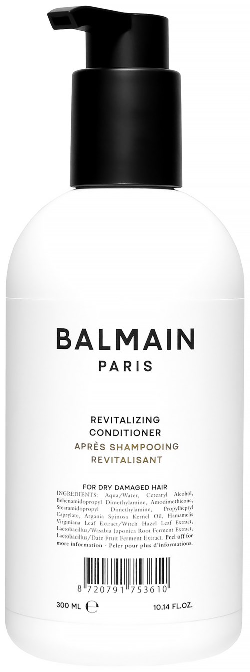 En vit flaska med svart pump märkt Balmain Paris, för återupplivande balsam för torrt skadat hår.