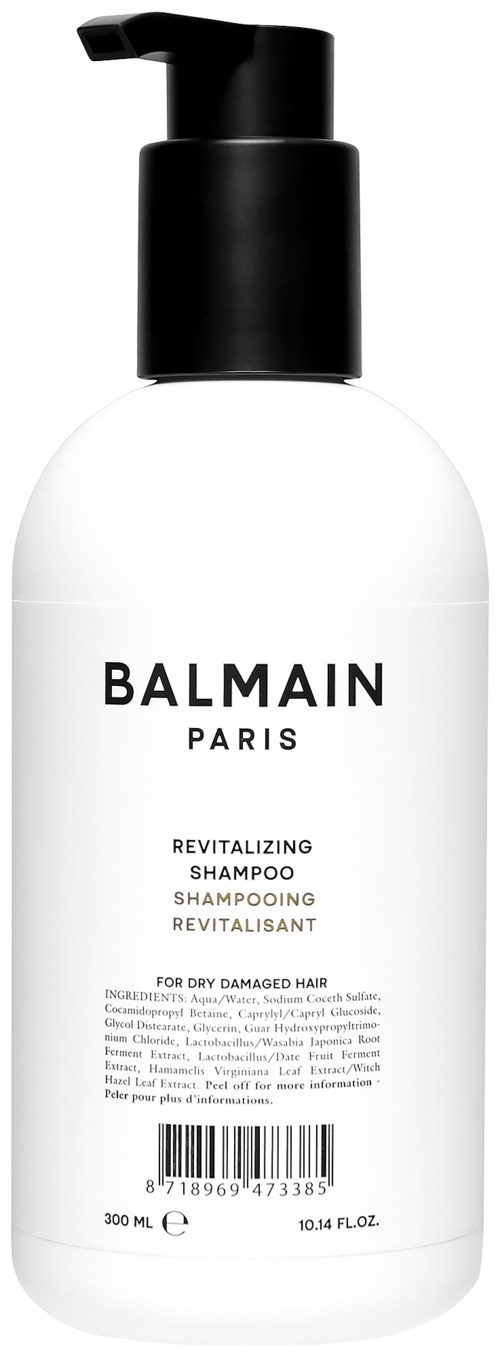 En vit flaska med svart pump märkt 'Balmain Paris' för återupplivande schampo för torrt hår.