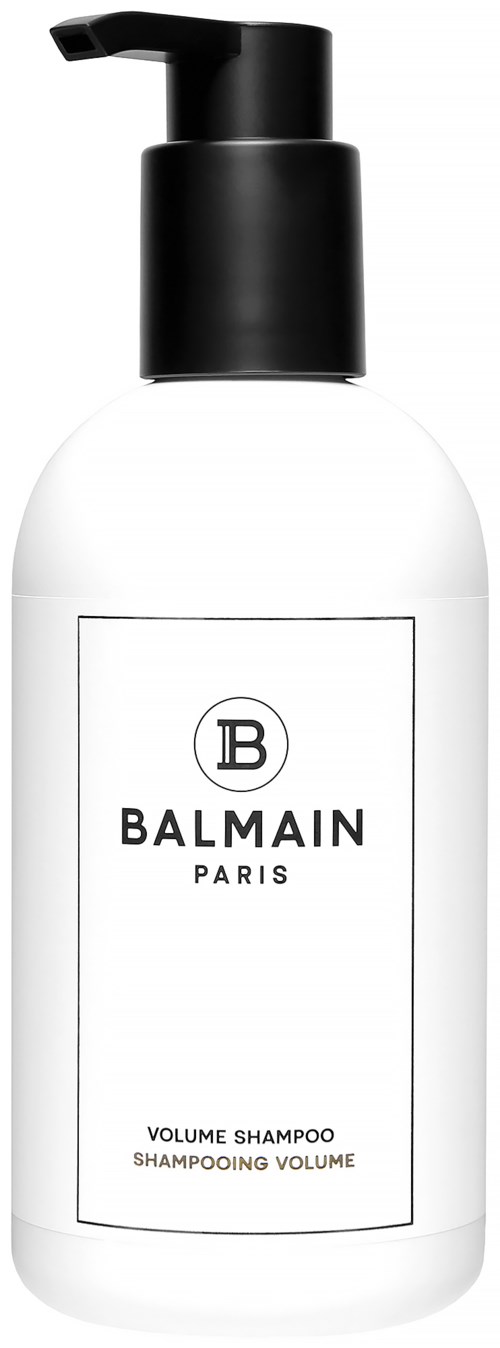 En vit flaska med svart pump märkt 'Balmain Paris Volume Shampoo'.