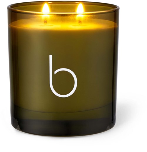 En mörk doftljus i ett glas med två tända lågor och ett vitt litet "b" på.