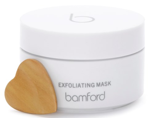 En hvit krukke merket 'EXFOLIATING MASK' med et trehjerte ved siden av.